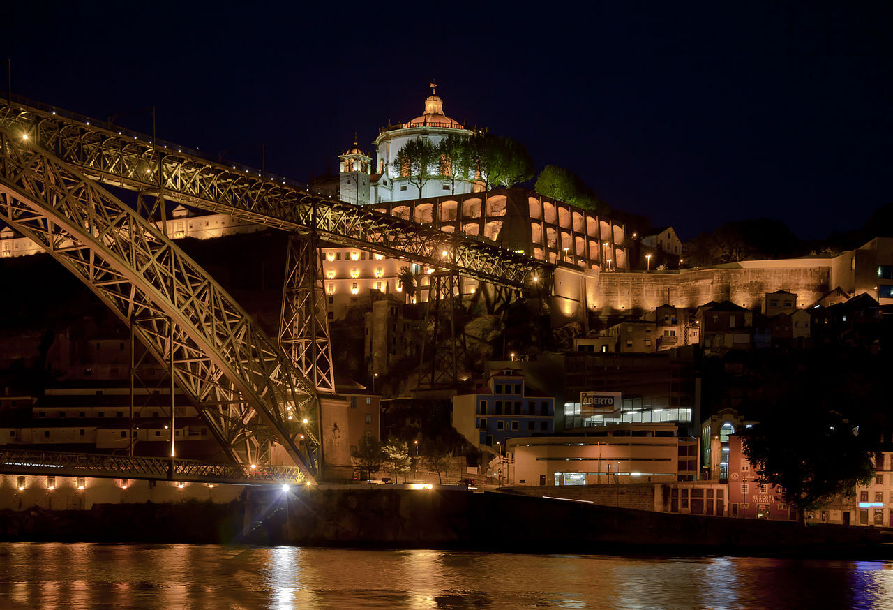 Night view of Dom Luís I Bridge and Serra do Pilar Monastery in Porto Portugal.