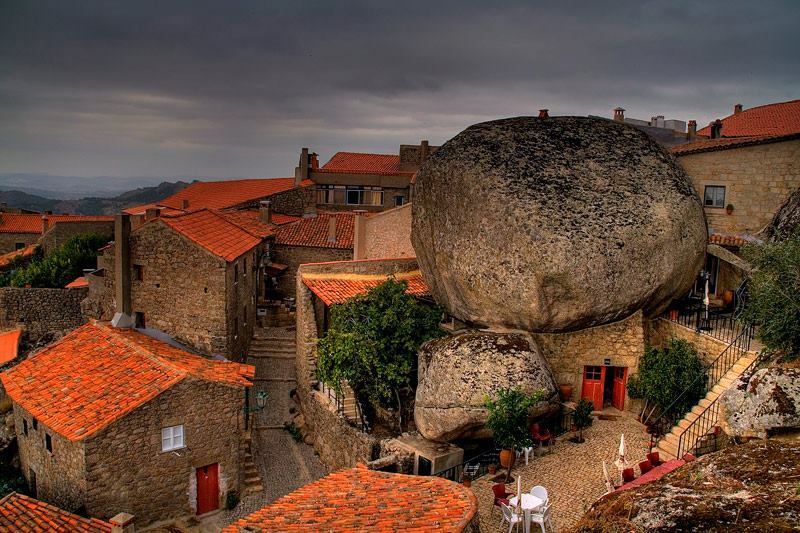 Ancient stone houses built into giant boulders in Monsanto village Portugal private tour.